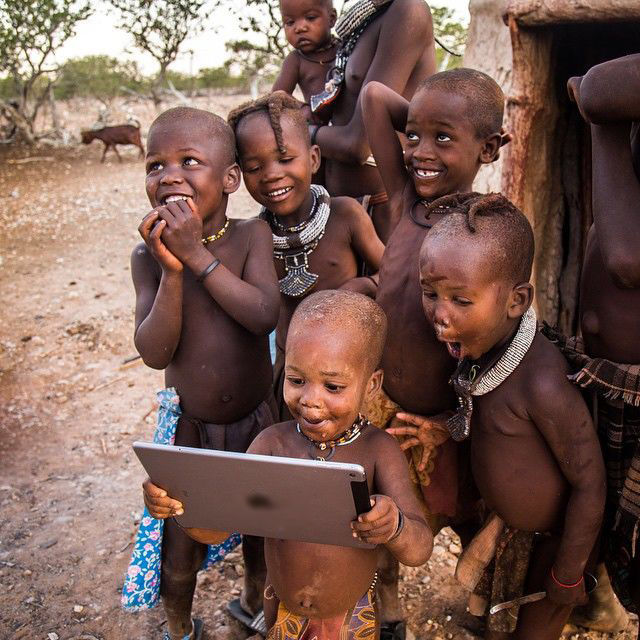 
Những cậu bé trong một bộ lạc lần đầu tiên tiếp xúc với máy tính bảng
