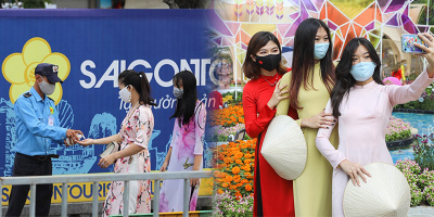 Xếp hàng giãn cách chờ đến lượt vào tham quan đường hoa Nguyễn Huệ