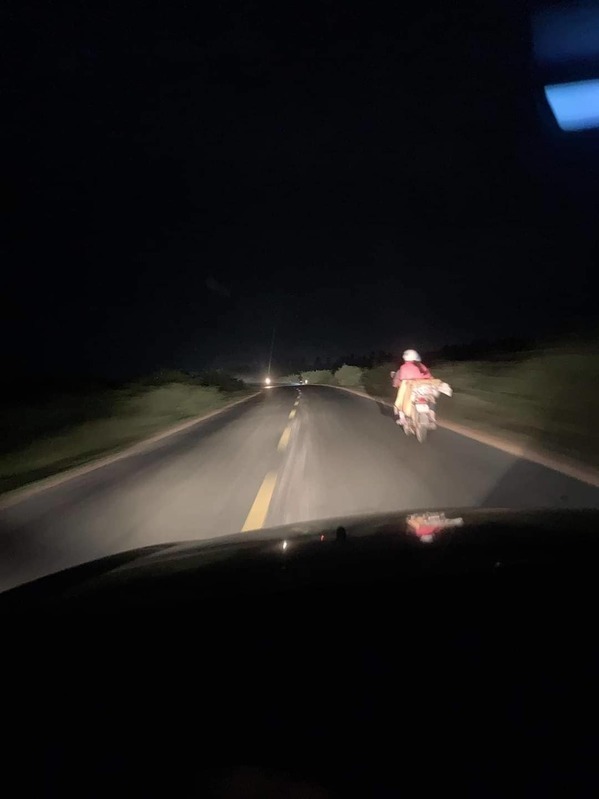  
Hình ảnh tài xế bật đèn pha giúp xe máy vượt qua quãng đường nguy hiểm (Ảnh chụp màn hình)