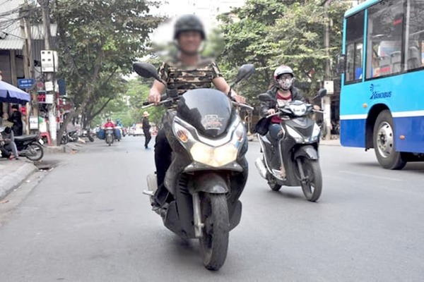  
Người tham gia giao thông bật đèn xe máy vào ban ngày (Ảnh: VTC News)