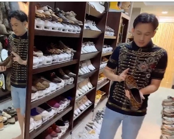  
Dương Triệu Vũ đang cầm trên tay đôi giày của nhà mốt Pháp chỉ có duy nhất một đôi ở Việt Nam. (Ảnh: Chụp màn hình)