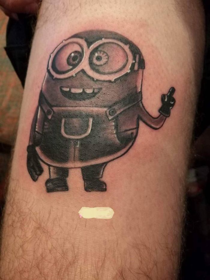 Purple Minion tattoo on the right calf