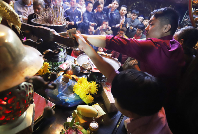 
Tại Lễ hội đền Trần, vẫn còn tình trạng hàng nghìn người chen lấn từ cổng chính để vào được sân đền Thiên Trường. Khi vào bên trong đền lại xô đẩy để vào được gần ban thờ xoa tiền lẻ vào bảo kiếm (Ảnh: VnExpress)