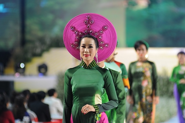 
Với vai trò đại sứ truyền cảm hứng áo dài, Trịnh Kim Chi xuất hiện vô cùng lộng lẫy và nổi bật với chiếc mấn khổng lồ sang trọng, quyền lực.