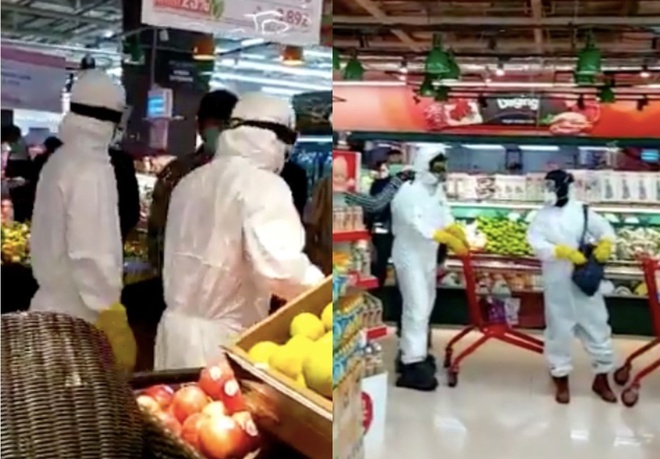  
Hình ảnh ghi lại hai người mặc đồ bảo hộ đi siêu thị gây lo lắng cho những người xung quanh. (Ảnh: Asia One)