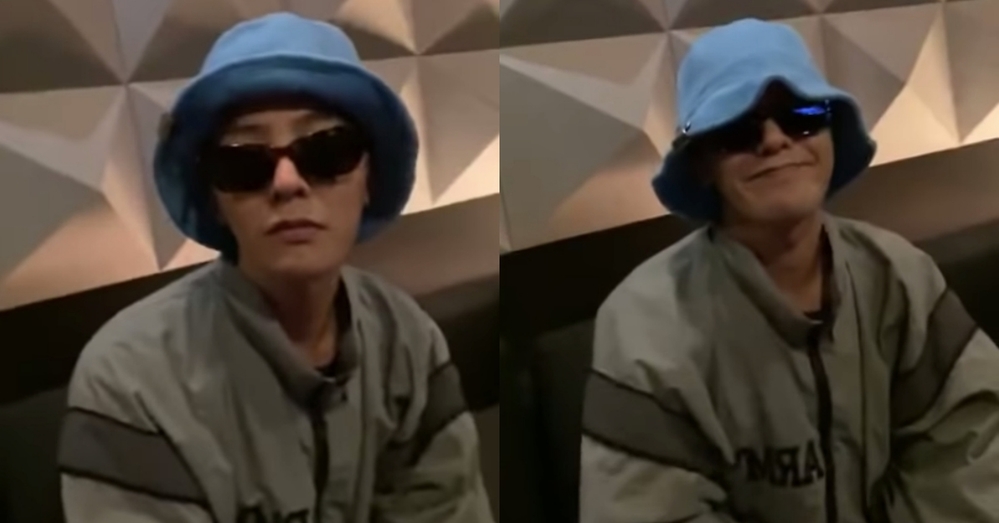  
G-Dragon xuất hiện và thử kính đàn em đưa (Ảnh: chụp màn hình).