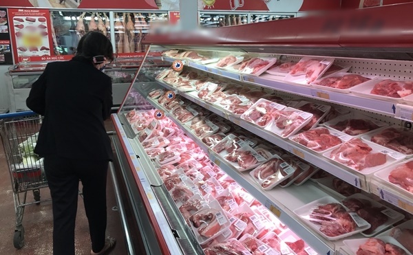  
Một người tiêu dùng đang lựa chọn thịt heo được bày bán trong siêu thị. (Ảnh: Tiêu Dùng)
