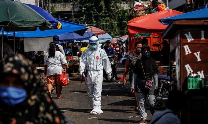  
Nhân viên y tế ở Indonesia đang đến 1 khu chợ để thu thập mẫu xét nghiệm Covid-19. (Ảnh: Reuters)