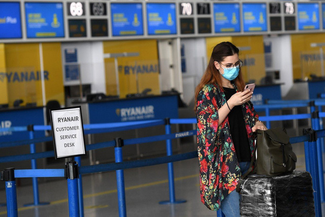  
Một hành khách đeo khẩu trang ở sân bay Anh (Ảnh: EPA)