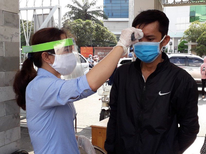  
Nhân viên y tế tiến hành đo thân nhiệt cho những người đến Bệnh viện Ung Bướu Thành phố Hồ Chí Minh. (Ảnh: Báo Pháp Luật)