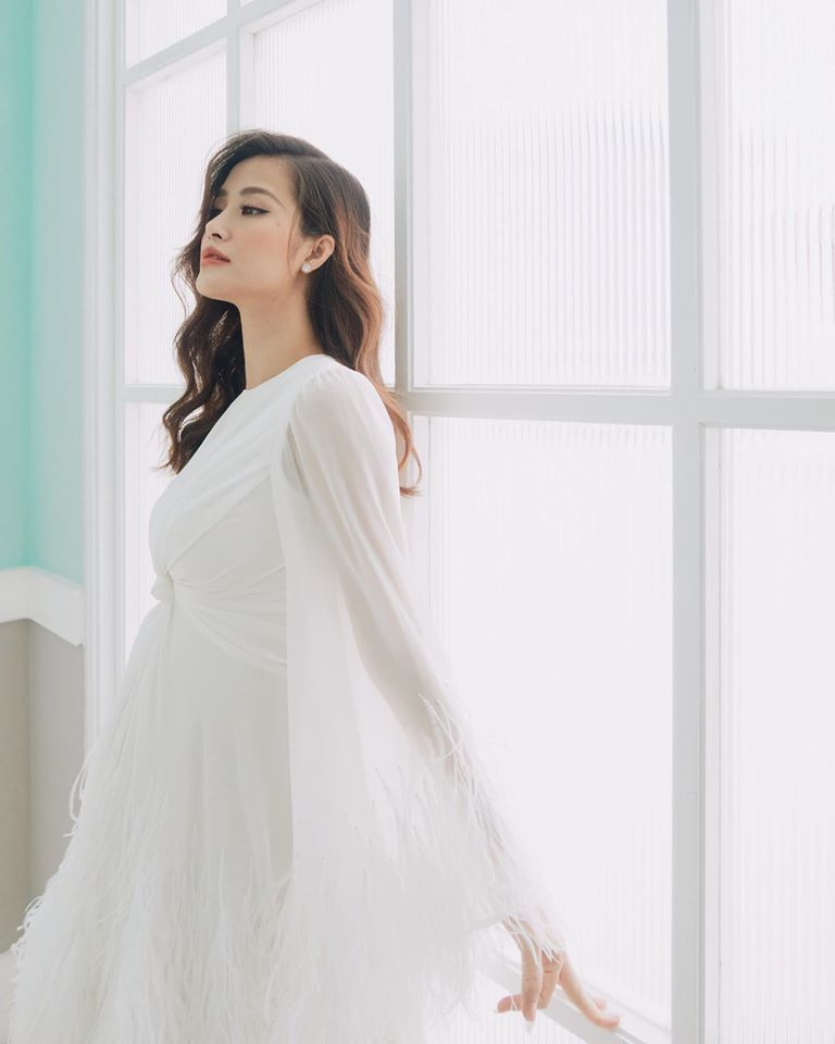 
Đông Nhi diện bộ váy suông tông trắng của NTK Lê Thanh Hoà trong chuyến du lịch Phú Quốc. (Ảnh: FBNV)