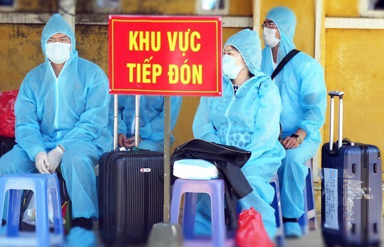 
Người Việt trở về từ Liên bang Nga ngồi chờ phân khu cách ly (Ảnh: Thanh Niên)