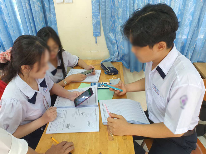  
Học sinh sử dụng điện thoại trong lớp để tìm kiếm thông tin phục vụ bài học (Ảnh: Người đưa tin)