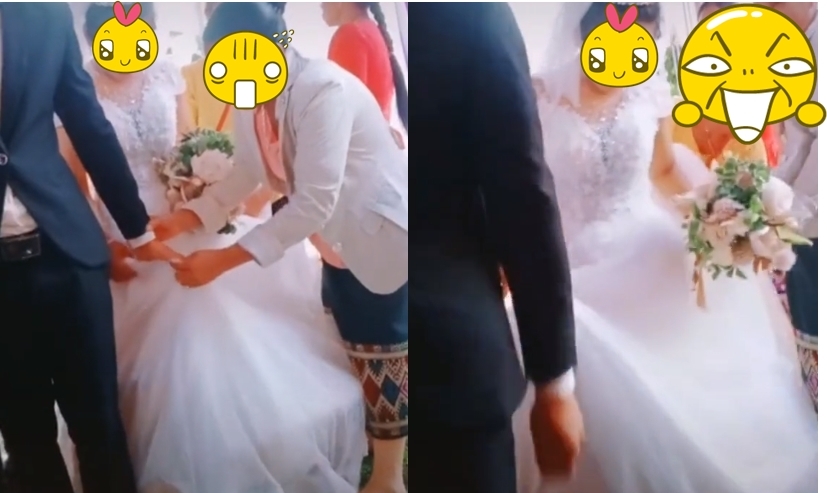  
Cả khi phụ huynh bắt cầm váy cô dâu, thanh niên cũng bỏ tay ra ngay lập tức. (Ảnh cắt từ clip)