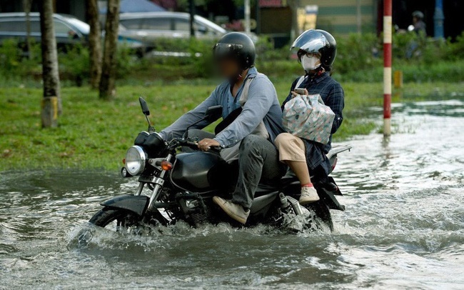
Nước dâng cao khiến người đi đường gặp nhiều khó khăn (Ảnh: VTV)