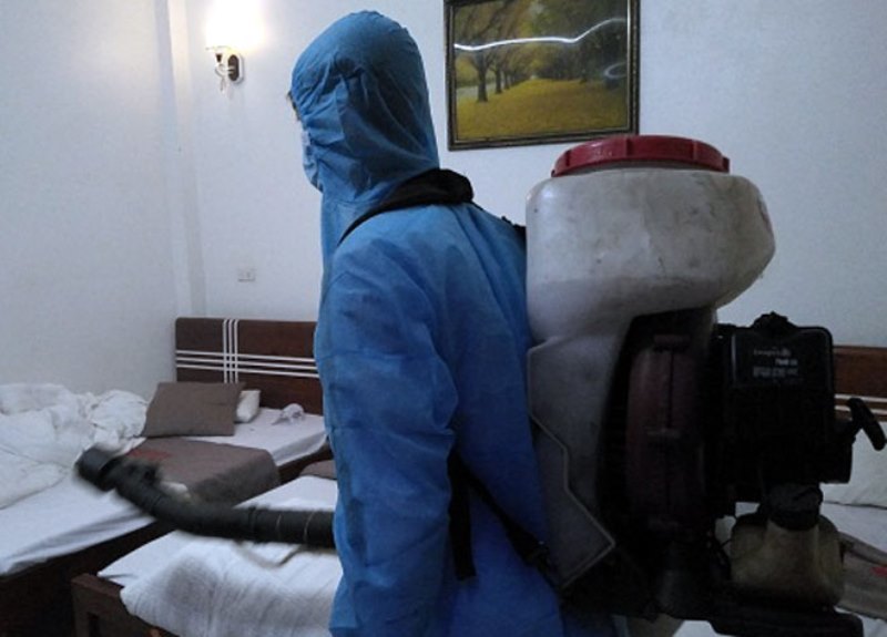  
Nhân viên y tế phun khử khuẩn bên trong khách sạn. (Ảnh: Báo Chính Phủ)