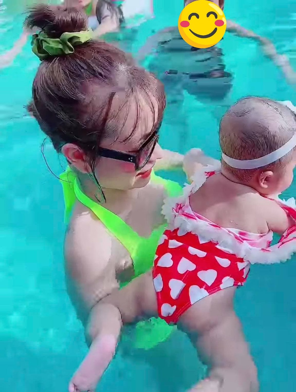 
Minnie vui đùa dưới nước trong vòng tay mẹ. (Ảnh: Chụp màn hình)