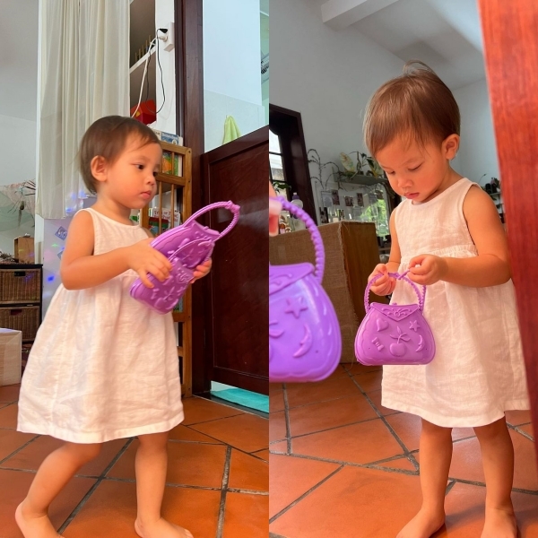 Lisa thích thú với chiếc túi xách màu tím trên tay, cầm mãi không rời. (Ảnh: Instagram henrylisaleon)