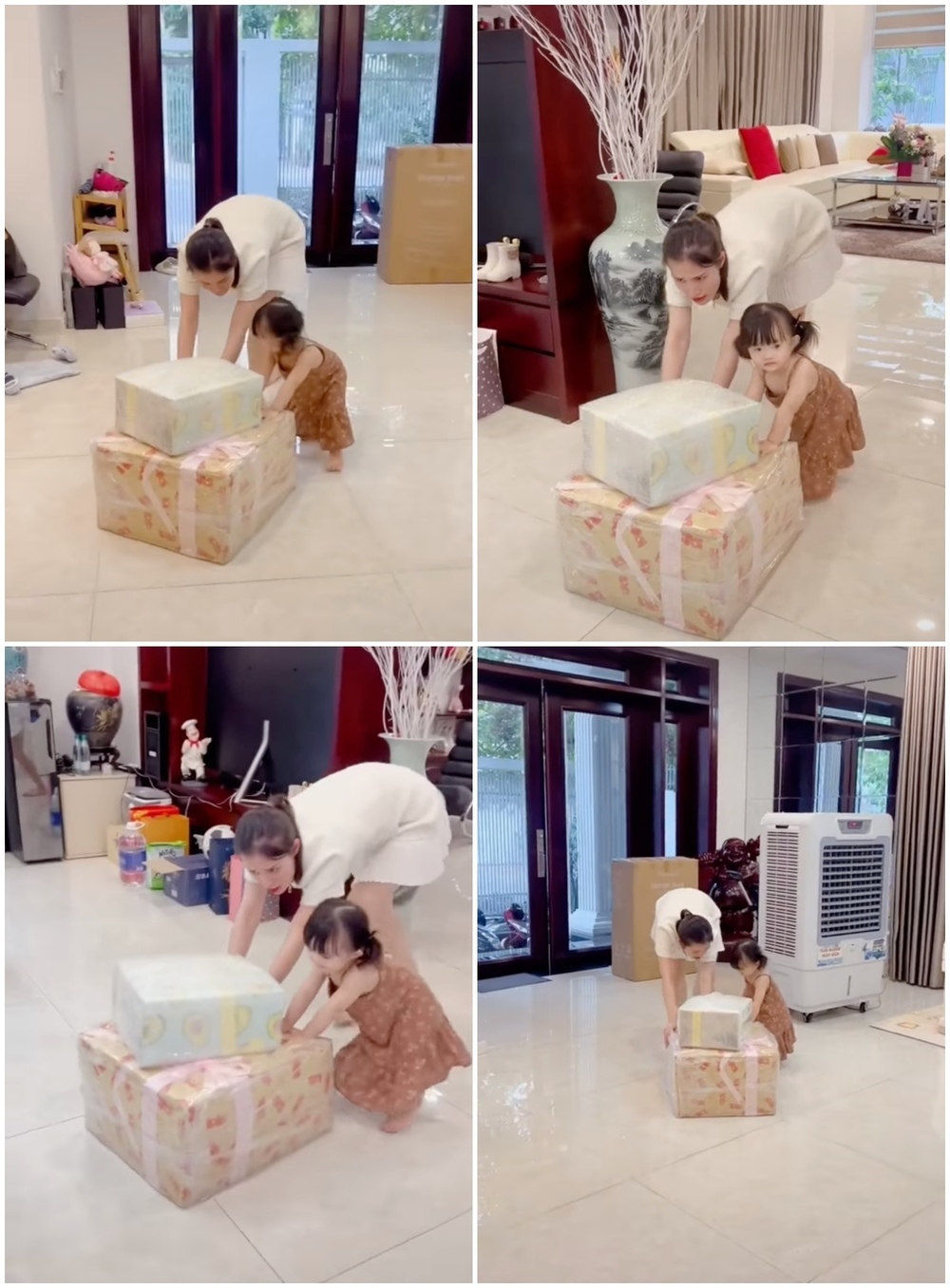  
Bé Winnie nhanh nhẹn, phụ giúp Đông Nhi đẩy những hộp quà to vào nhà một cách hứng thú. (Ảnh: FB Đông Nhi)