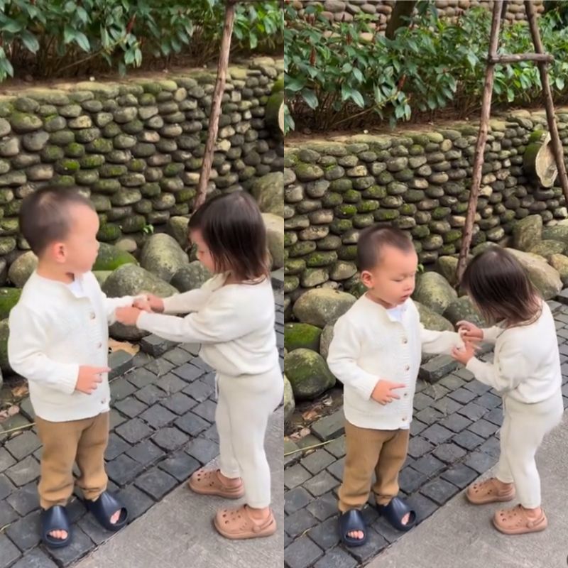  
Cô bé còn nhiệt tình giúp em trai xắn tay áo. (Ảnh: Chụp màn hình TikTok @koolcheng.trinhtutrung)